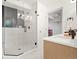 Bathroom with glass shower, tile and floating vanity with quartz countertop at 1440 S Dahlia St, Denver, CO 80222