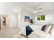 Bright bedroom featuring a ceiling fan, view to backyard, and view to the ensuite at 1440 S Dahlia St, Denver, CO 80222