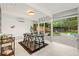 Bright dining room with modern furnishings and view to the backyard patio and pool at 1440 S Dahlia St, Denver, CO 80222