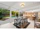 Bright dining room with modern furnishings and view of the kitchen and backyard pool at 1440 S Dahlia St, Denver, CO 80222