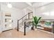 Inviting foyer features a modern staircase, hardwood floors, and an open view of the home at 1440 S Dahlia St, Denver, CO 80222
