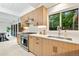 Bright kitchen featuring stainless steel appliances, wood cabinets, and a window offering an inviting view at 1440 S Dahlia St, Denver, CO 80222