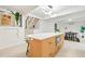 Bright, modern kitchen features an island, stainless steel appliances, and staircase leading to another level at 1440 S Dahlia St, Denver, CO 80222