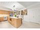 Bright, modern kitchen features an island, stainless steel appliances, and staircase leading to another level at 1440 S Dahlia St, Denver, CO 80222