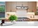 Bright kitchen featuring stainless steel appliances, wood cabinets, and a view of the backyard at 1440 S Dahlia St, Denver, CO 80222