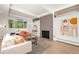 Bright and airy living room with a fireplace, modern décor, and large windows at 1440 S Dahlia St, Denver, CO 80222