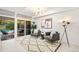 Bright living room with modern decor, statement lighting, and sliding door to a patio with a pool view at 1440 S Dahlia St, Denver, CO 80222