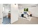 Bright main bedroom featuring hardwood floors, mini-split AC, backyard view, and an attached bathroom at 1440 S Dahlia St, Denver, CO 80222