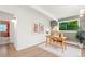 Home office with a hardwood floor, area rug, stylish wallpaper and backyard view at 1440 S Dahlia St, Denver, CO 80222