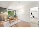 Bright office space with hardwood floors, area rug, desk and backyard view at 1440 S Dahlia St, Denver, CO 80222