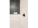 Close up of a shower with tile surround and toiletries at 1440 S Dahlia St, Denver, CO 80222