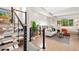 Modern staircase with metal railings leading to a stylish living area, flooded with natural light at 1440 S Dahlia St, Denver, CO 80222