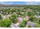 Stunning aerial view of a neighborhood with lush green trees and mountain backdrop at 14887 W 49Th Pl, Golden, CO 80403