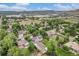 Expansive aerial shot captures the serene neighborhood with scenic lake and mountain views at 14887 W 49Th Pl, Golden, CO 80403