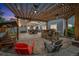 Back patio with pergola, built-in BBQ, ceiling fans, swing, and cozy seating area at 14887 W 49Th Pl, Golden, CO 80403