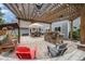 Cozy backyard patio featuring an outdoor kitchen, swing, and stone seating for relaxing or entertaining at 14887 W 49Th Pl, Golden, CO 80403