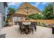 Backyard patio with an outdoor kitchen and grill area, as well as an umbrella covered dining table at 14887 W 49Th Pl, Golden, CO 80403