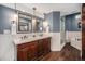 Stylish bathroom featuring double vanity, soaking tub, and glass-enclosed shower at 14887 W 49Th Pl, Golden, CO 80403