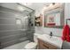Modern bathroom with a glass-enclosed shower, stylish vanity, and rustic wood framed mirror at 14887 W 49Th Pl, Golden, CO 80403