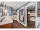 Bathroom with wood tile floors, double vanity, large mirror, soaking tub and walk-in closet at 14887 W 49Th Pl, Golden, CO 80403