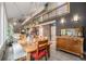 Elegant dining area with a large table, custom lighting, and an open view to the living space and staircase at 14887 W 49Th Pl, Golden, CO 80403