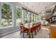 Dining room with large windows showcasing the backyard and staircase leading to the second floor living area at 14887 W 49Th Pl, Golden, CO 80403
