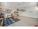 Spacious garage with epoxy floors, storage cabinets, and work benches for projects or hobbies at 14887 W 49Th Pl, Golden, CO 80403