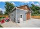 Garage exterior with wood door, basketball hoop, and ample space for parking at 14887 W 49Th Pl, Golden, CO 80403