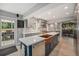 Bright, renovated kitchen with a large island, copper fixtures, and stainless steel appliances, seamlessly integrated at 14887 W 49Th Pl, Golden, CO 80403