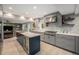 Modern kitchen featuring gray cabinetry, a white countertop, a large island, and a seamless open floor plan at 14887 W 49Th Pl, Golden, CO 80403
