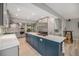 An open concept kitchen boasts ample counter space, stainless appliances, and stylish blue island with seating at 14887 W 49Th Pl, Golden, CO 80403