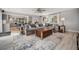Inviting living room adjacent to the kitchen, complete with a large sectional sofa and stylish decor at 14887 W 49Th Pl, Golden, CO 80403