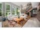 Bright living room offering large windows, comfortable seating, a modern staircase, and an open airy feel at 14887 W 49Th Pl, Golden, CO 80403