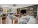 Cozy living room featuring a reclaimed wood accent wall, comfortable seating, and bright natural light at 14887 W 49Th Pl, Golden, CO 80403