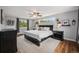 Spacious bedroom with wood floors, ceiling fan, and natural light from the lovely windows at 14887 W 49Th Pl, Golden, CO 80403