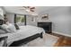 Bedroom with black dresser, wood floors, and a ceiling fan create a cozy atmosphere at 14887 W 49Th Pl, Golden, CO 80403