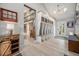 Spacious mudroom with custom built-in storage, wood accents, and a view into the open-concept living space at 14887 W 49Th Pl, Golden, CO 80403