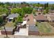 Features a home with solar panels, a patio, and lush landscaping within a neighborhood with city views at 3036 Birch St, Denver, CO 80207