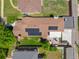 Stunning aerial view of home with solar panels, a back patio with seating, and manicured lawn and landscaping at 3036 Birch St, Denver, CO 80207