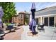 Spacious backyard with lush landscaping, including a serene seating area and outdoor decor at 3036 Birch St, Denver, CO 80207