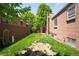 A charming backyard with green grass and a wood fence providing privacy at 3036 Birch St, Denver, CO 80207