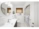 Bright bathroom featuring white hexagon floor tile, shower with patterned curtain, modern vanity and fixtures at 3036 Birch St, Denver, CO 80207