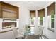 Bright breakfast nook featuring a glass table, comfortable seating, and natural light from multiple windows at 3036 Birch St, Denver, CO 80207