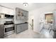 Modern kitchen features stainless steel appliances, gray cabinets, subway tile backsplash, and an eat-in area at 3036 Birch St, Denver, CO 80207