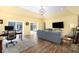 Spacious living room featuring hardwood floors, yellow walls, sliding glass doors, and a comfortable seating area at 3036 Birch St, Denver, CO 80207