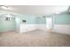 Open living room with fresh paint, neutral carpet, and easy access to other rooms at 3036 Birch St, Denver, CO 80207