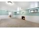 Bright living room with fireplace, neutral carpet, and updated wall color at 3036 Birch St, Denver, CO 80207