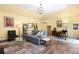 Inviting living room featuring yellow walls, a comfortable couch, hardwood floors, and recessed lighting at 3036 Birch St, Denver, CO 80207