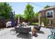 Spacious backyard with outdoor seating, landscaping, and a cozy firepit, perfect for entertaining at 3036 Birch St, Denver, CO 80207