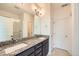 Bathroom features double granite vanity, modern fixtures, and walk-in shower with a white tile surround at 12843 W Nevada Pl, Lakewood, CO 80228